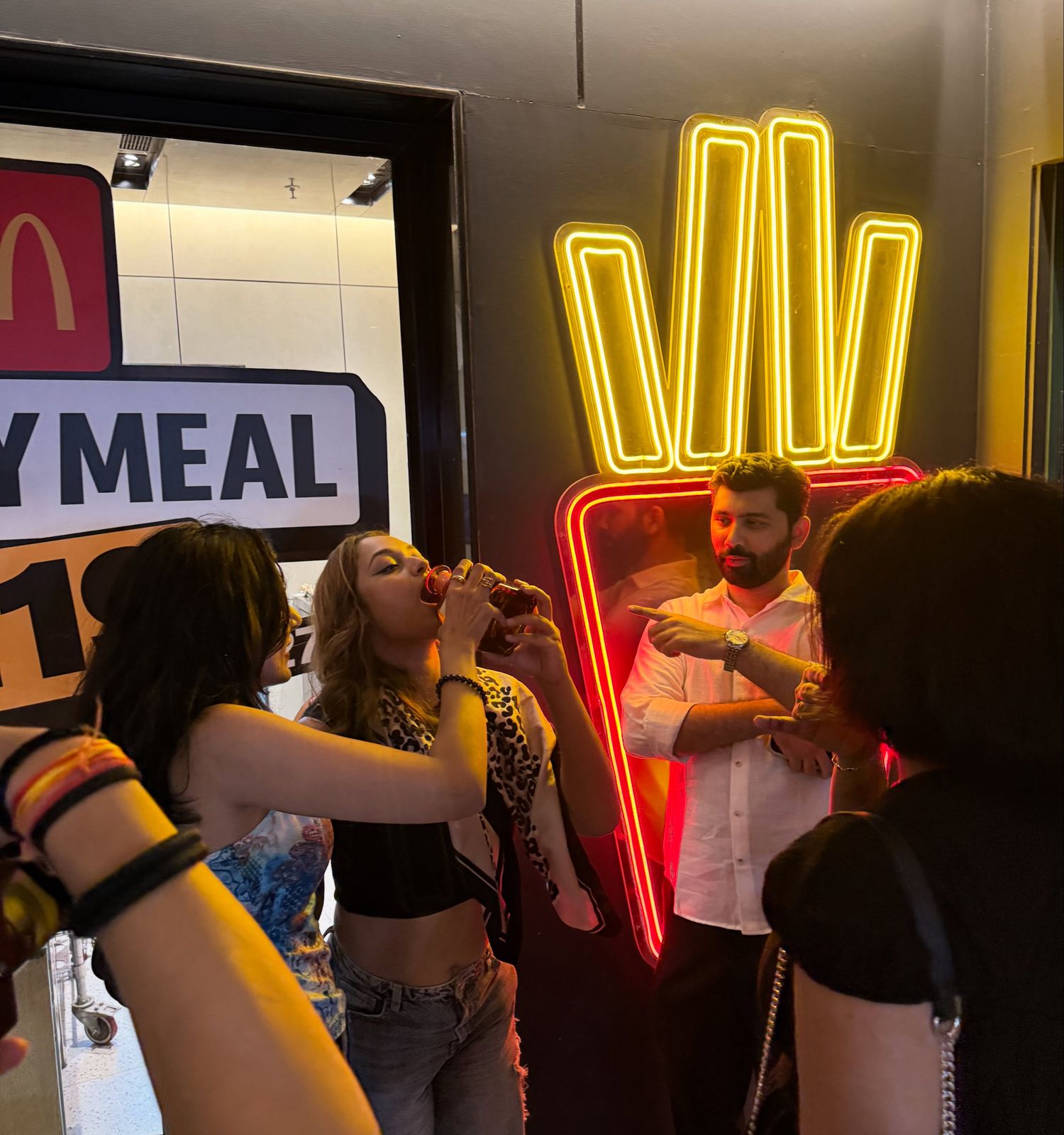 Guests laughing under a neon sign on an ASH pub crawl