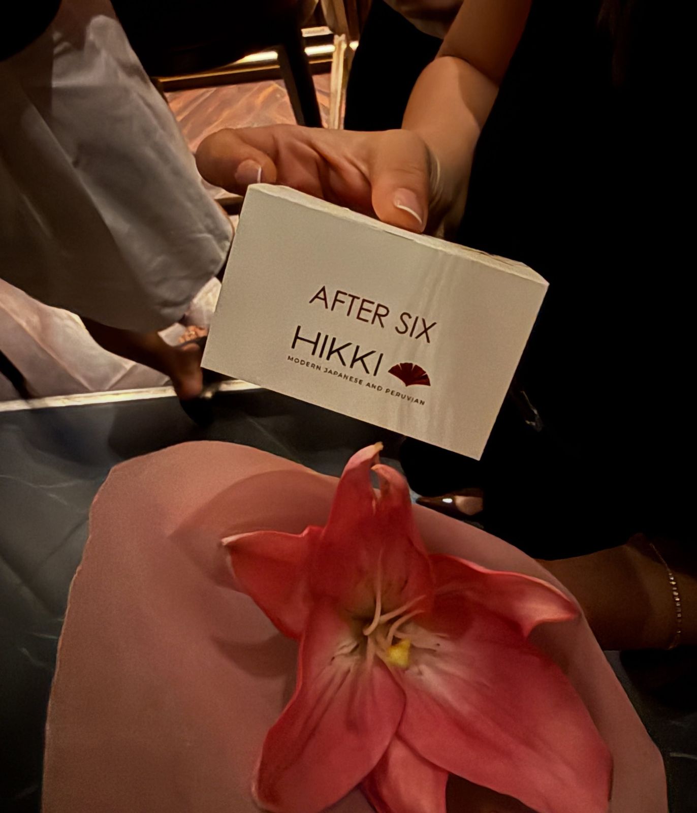 An After Six place card at Hikki, with a lily on the plate